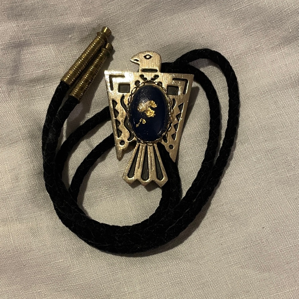 Gold Thunderbird Bolo Tie with Blue Stone